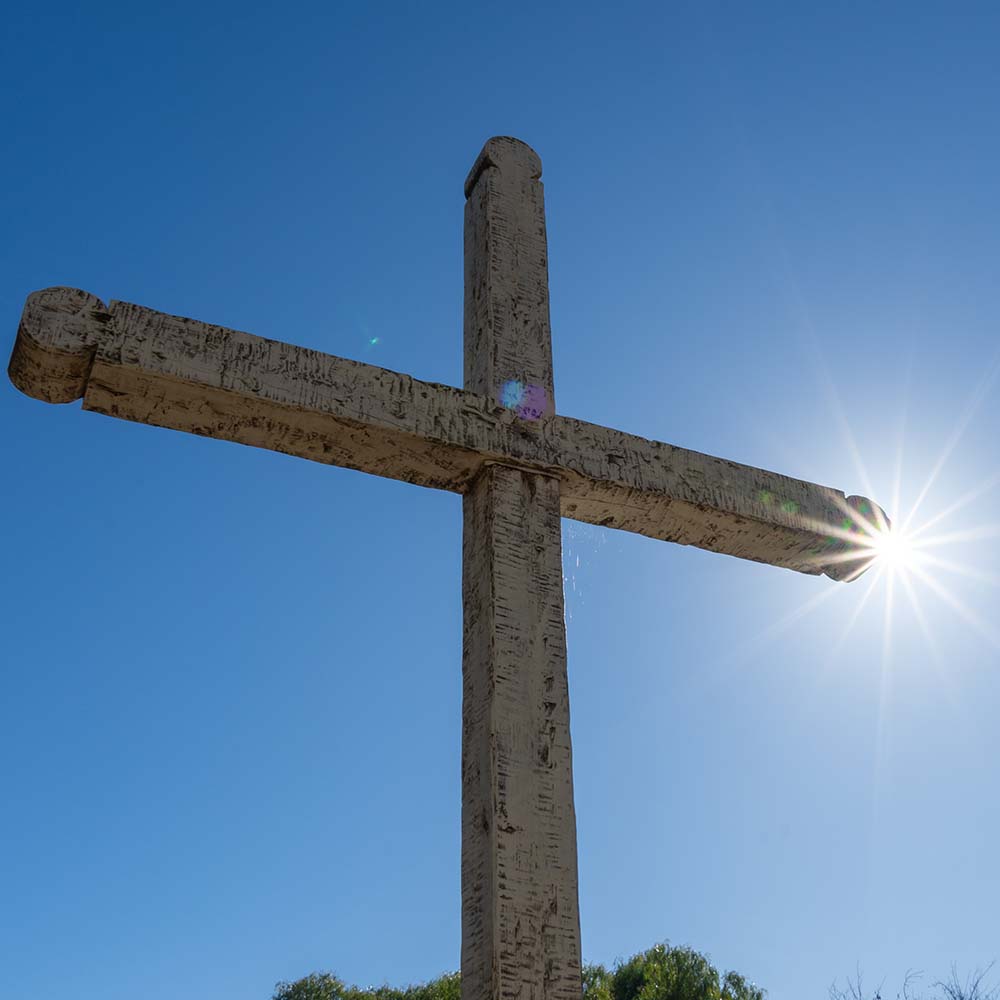 Cross with sunshine behind it