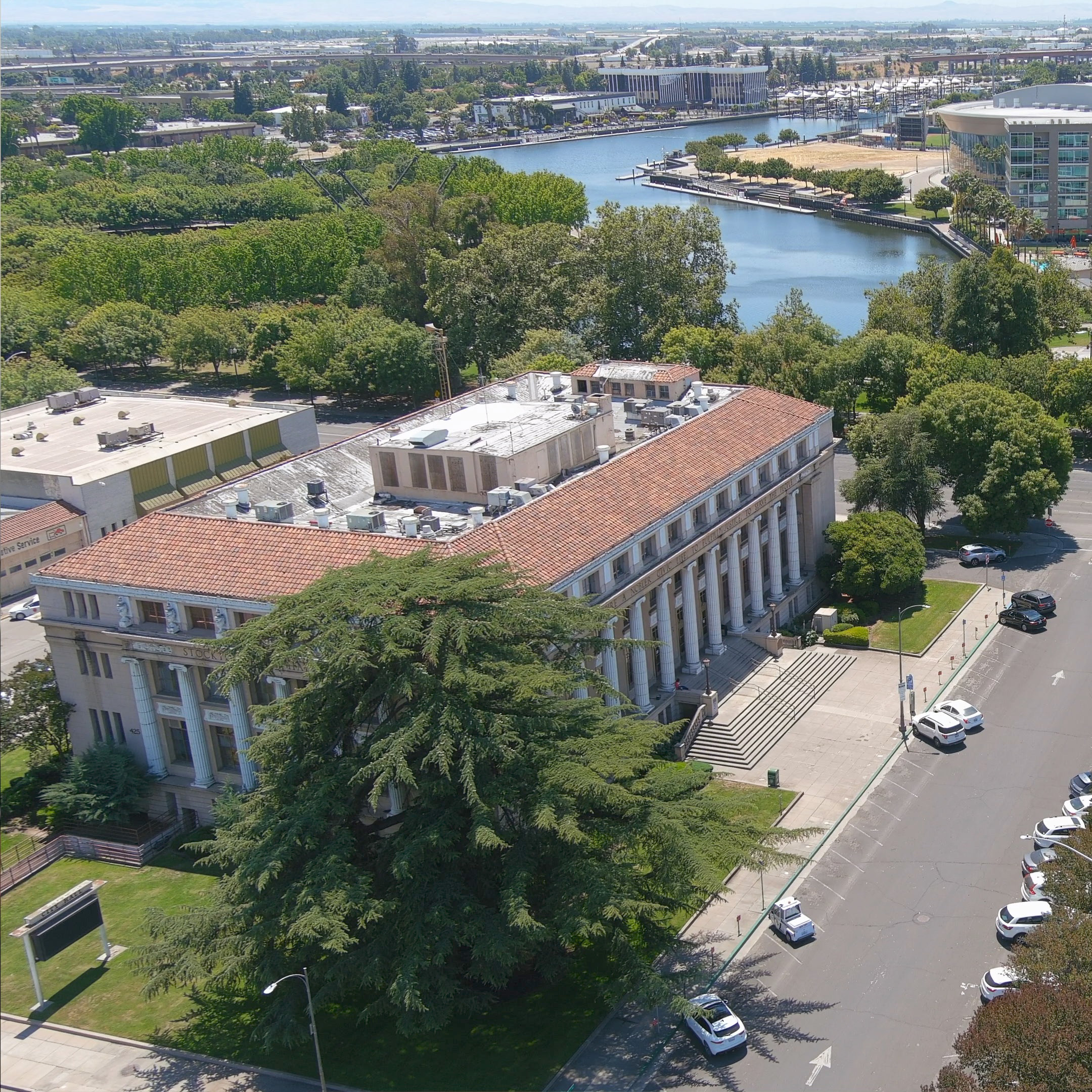 Stockton City Hall build via drone with city and water in background